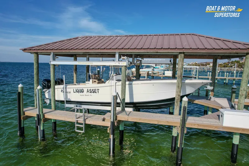 Slide: The Image of 2018 Key West Billistic 351 Center Console boat docked in marina, clear blue water. - 30