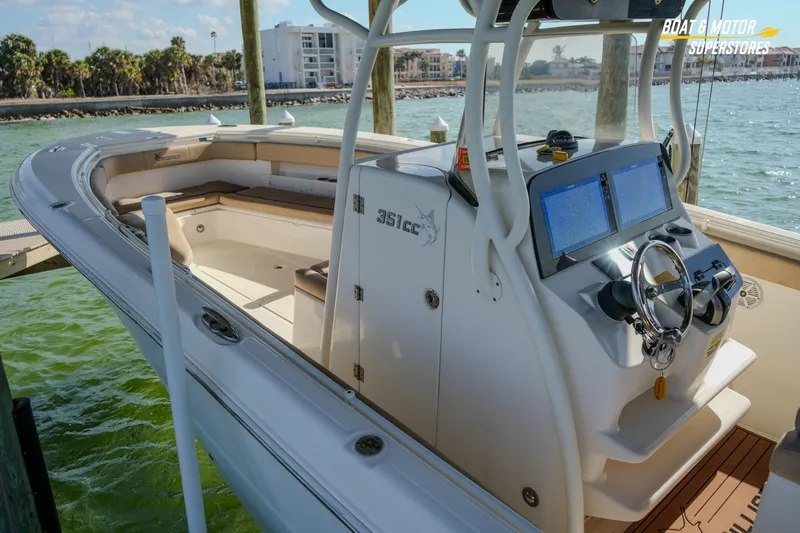 Slide: The Image of 2018 Key West Billistic 351 Center Console boat docked, featuring modern navigation equipment. - 40
