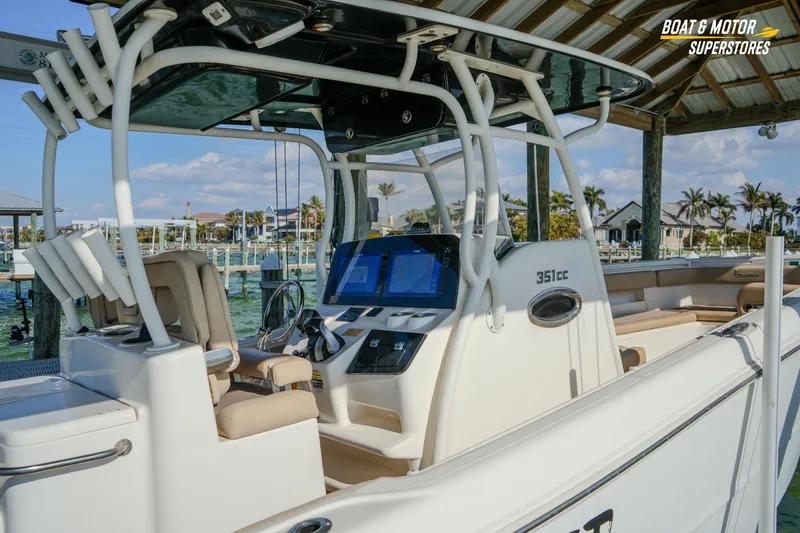 Slide: The Image of 2018 Key West Billistic 351 Center Console boat docked at marina, featuring modern helm. - 45