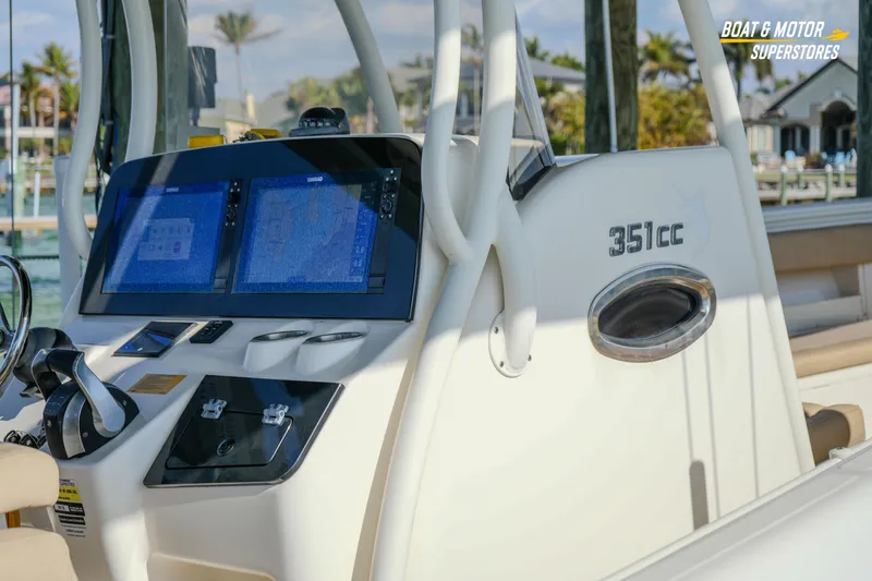 Slide: The Image of 2018 Key West Billistic 351 Center Console dashboard with navigation screens and controls. - 47