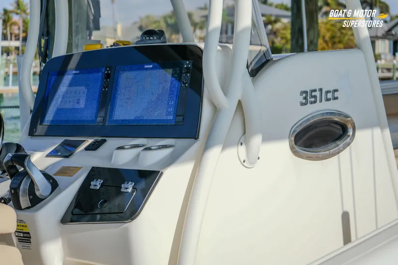 Slide: The Image of 2018 Key West Billistic 351 Center Console dashboard with dual navigation screens. - 48