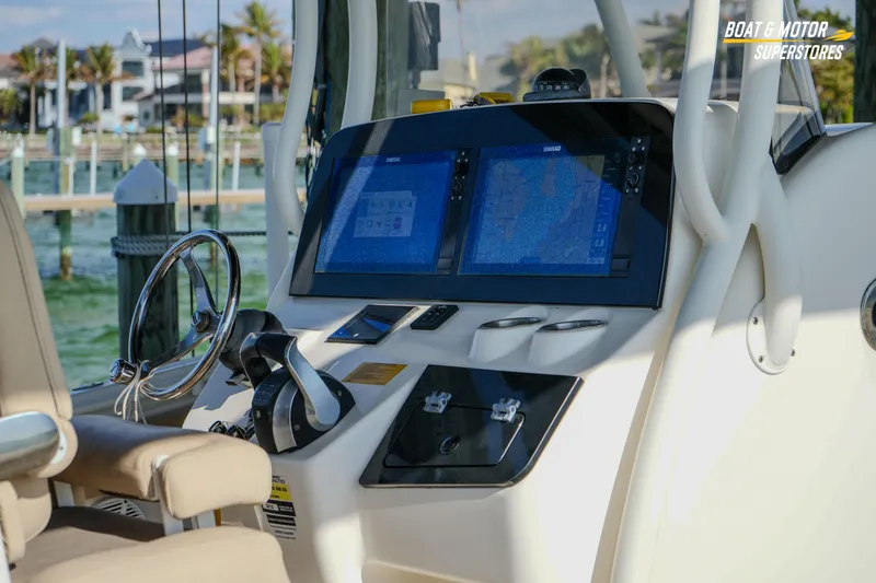 Slide: The Image of 2018 Key West Billistic 351 Center Console helm with dual navigation screens and steering wheel. - 49