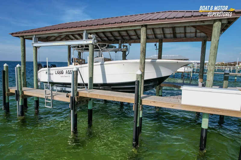 Slide: The Image of 2018 Key West Billistic 351 Center Console boat docked under a covered lift. - 5