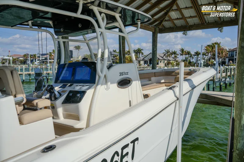 Slide: The Image of 2018 Key West Billistic 351 Center Console docked under a wooden canopy. - 52