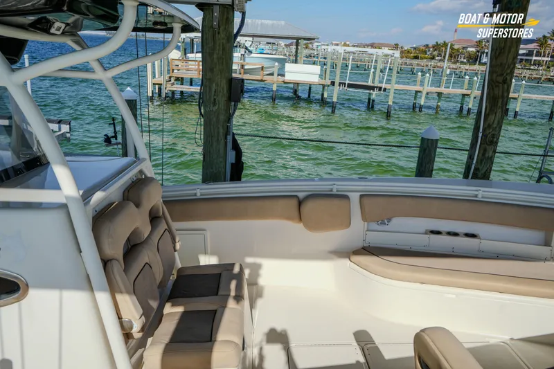 Slide: The Image of 2018 Key West Billistic 351 Center Console boat interior at a marina. - 61
