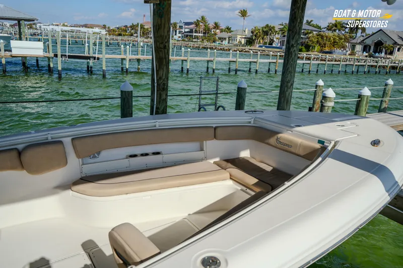 Slide: The Image of 2018 Key West Billistic 351 Center Console boat docked by waterfront homes. - 62