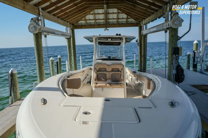Slide: The Image of 2018 Key West Billistic 351 Center Console boat docked under a wooden shelter. - 63