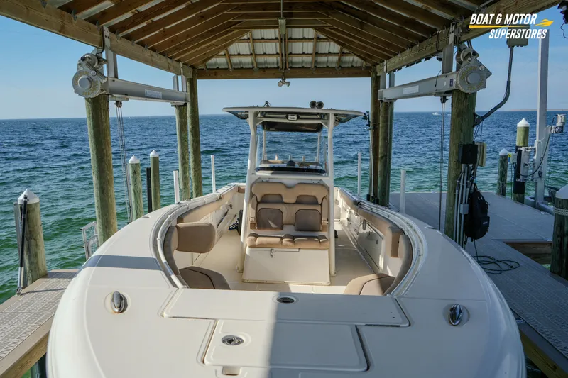 Slide: The Image of 2018 Key West Billistic 351 Center Console boat docked under a wooden shelter. - 67