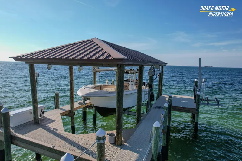 Slide: The Image of 2018 Key West Billistic 351 Center Console boat docked under a covered pier. - 8