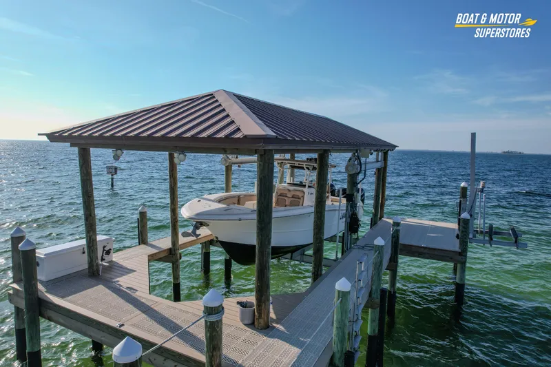 Slide: The Image of 2018 Key West Billistic 351 Center Console boat docked under a covered pier. - 9