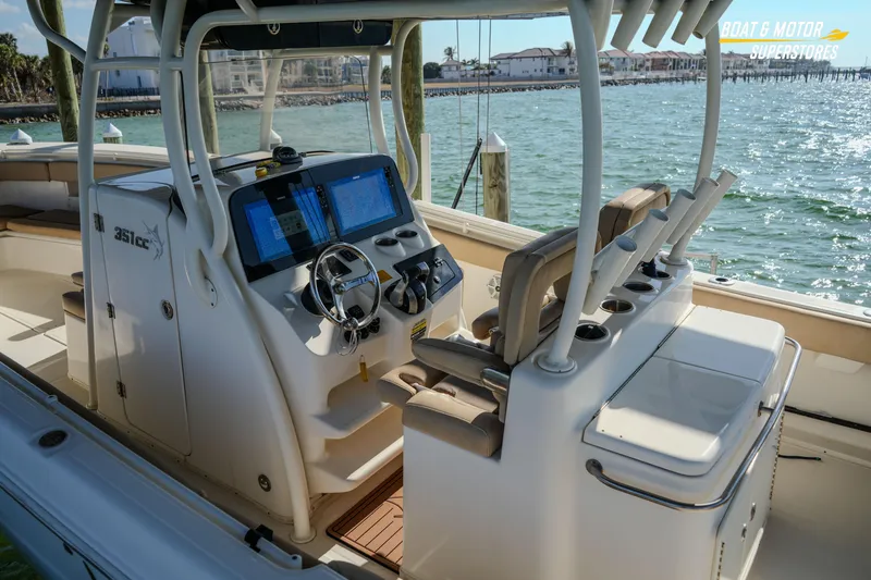 Slide: The Image of 2018 Key West Billistic 351 Center Console boat interior with navigation screens and seating. - 90