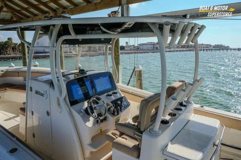 Slide: The Image of 2018 Key West Billistic 351 Center Console boat with dual screens, docked by the water. - 91