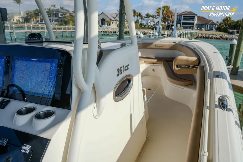 Slide: The Image of 2018 Key West Billistic 351 Center Console boat docked, featuring modern navigation equipment. - 96