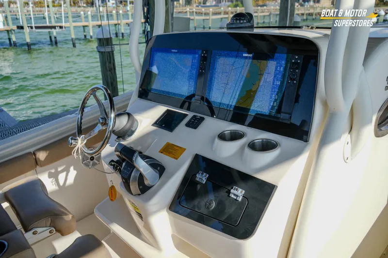Slide: The Image of 2018 Key West Billistic 351 Center Console dashboard with navigation screens and controls. - 97