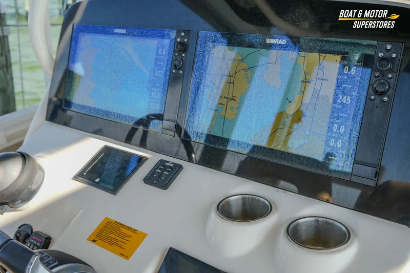 Slide: The Image of 2018 Key West Billistic 351 Center Console dashboard with navigation screens. - 98