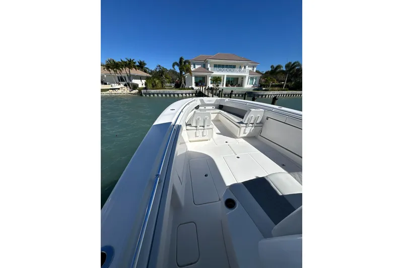 Slide: The Image of 2019 Invincible 39 Open Fisherman boat docked near waterfront home. - 10