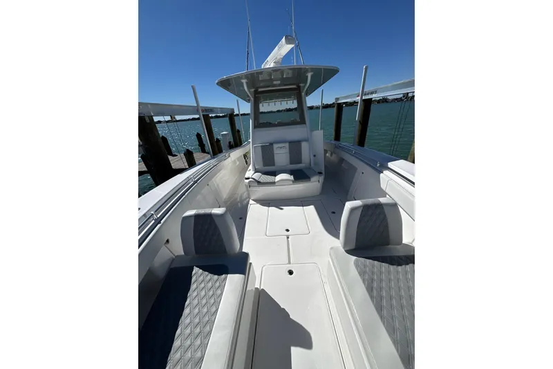 Slide: The Image of 2019 Invincible 39 Open Fisherman boat docked, showcasing spacious seating and sleek design. - 11