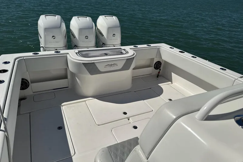 Slide: The Image of 2019 Invincible 39 Open Fisherman boat with triple engines on calm water. - 15