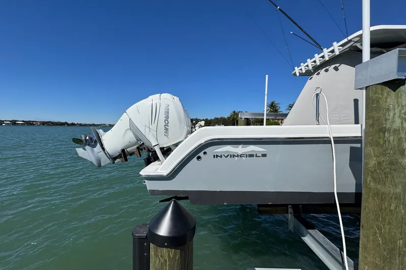 Slide: The Image of 2019 Invincible 39 Open Fisherman boat with Mercury outboard engine docked by the water. - 18