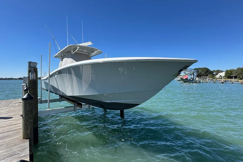 Slide: The Image of 2019 Invincible 39 Open Fisherman boat docked on clear blue water. - 19