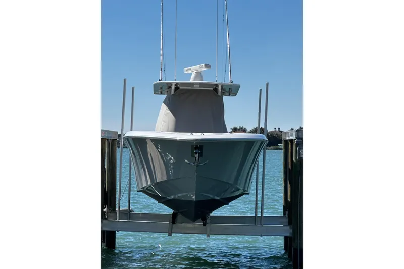 Slide: The Image of 2019 Invincible 39 Open Fisherman boat docked on a lift, clear blue sky. - 21