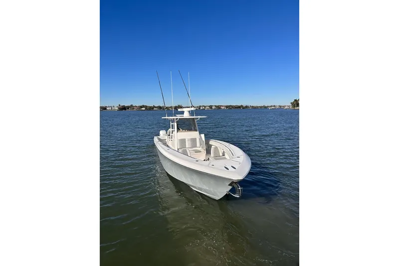 Slide: The Image of 2019 Invincible 39 Open Fisherman boat on calm water under clear blue sky. - 23