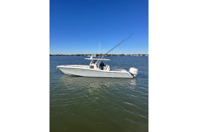 Slide: The Image of 2019 Invincible 39 Open Fisherman boat on calm water under clear blue sky. - 24