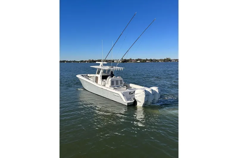 Slide: The Image of 2019 Invincible 39 Open Fisherman boat on calm water, clear blue sky. - 25