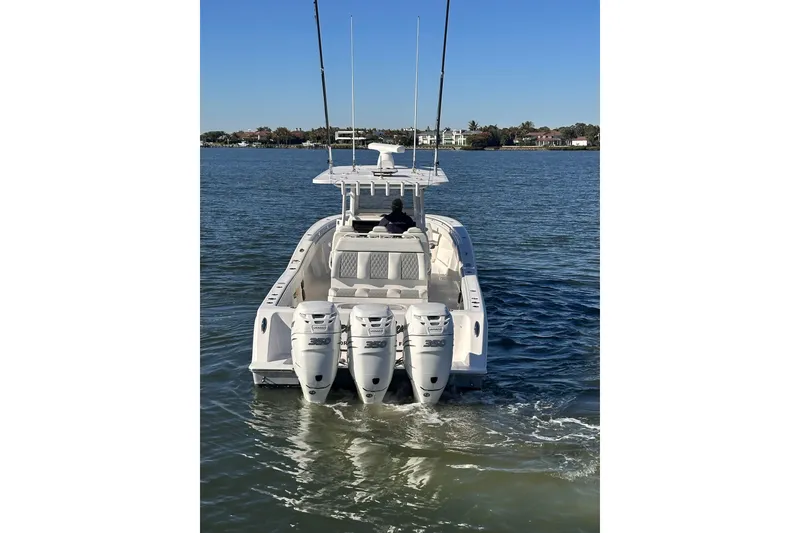 Slide: The Image of 2019 Invincible 39 Open Fisherman boat with triple engines on calm water. - 27