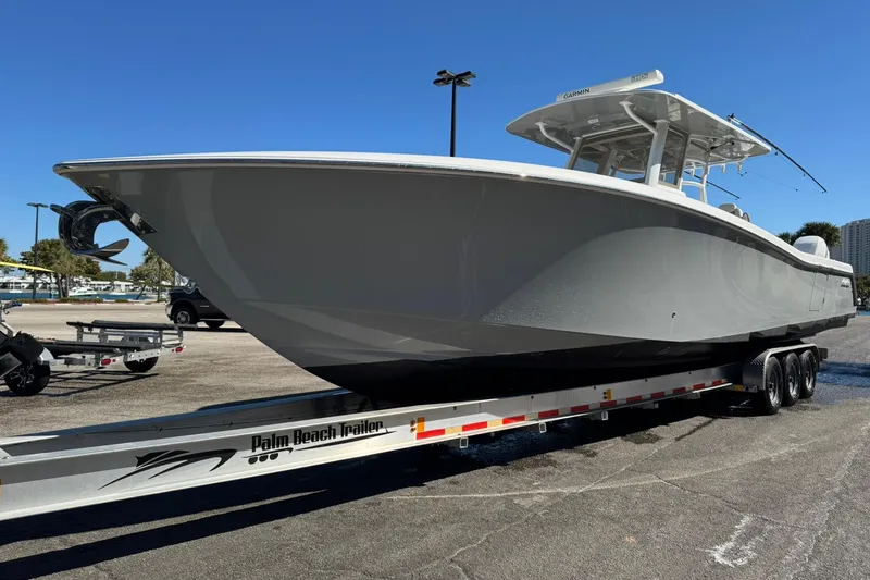 Slide: The Image of 2019 Invincible 39 Open Fisherman boat on trailer, parked outdoors under clear blue sky. - 28