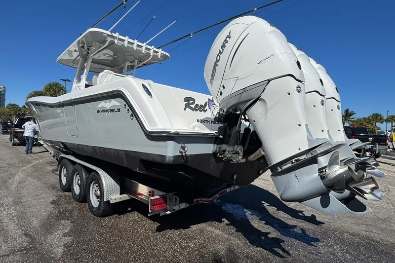 Slide: The Image of 2019 Invincible 39 Open Fisherman boat with triple Mercury engines on a trailer. - 29