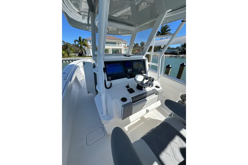 Slide: The Image of 2019 Invincible 39 Open Fisherman boat cockpit with modern controls and waterfront view. - 3