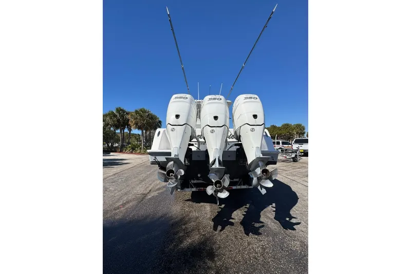Slide: The Image of 2019 Invincible 39 Open Fisherman with triple outboard engines, parked on a sunny day. - 30