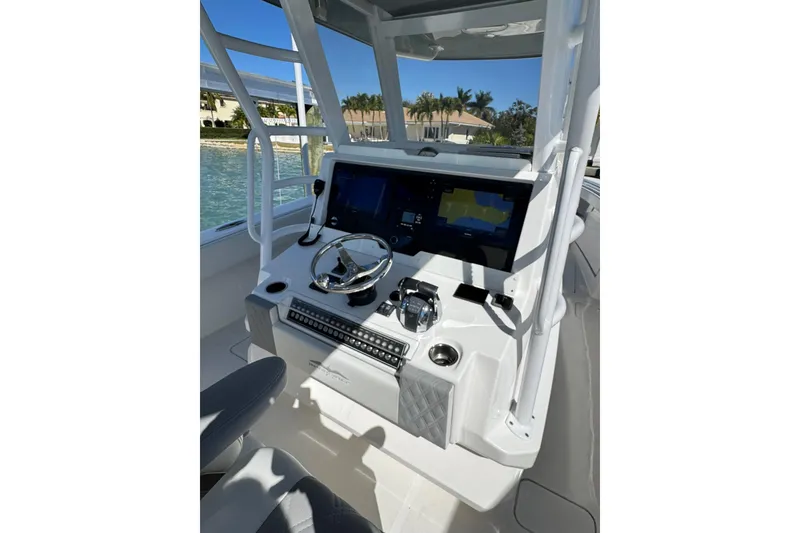 Slide: The Image of 2019 Invincible 39 Open Fisherman boat console with steering wheel and navigation screens. - 4
