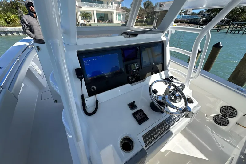 Slide: The Image of 2019 Invincible 39 Open Fisherman boat helm with modern navigation equipment and steering wheel. - 5