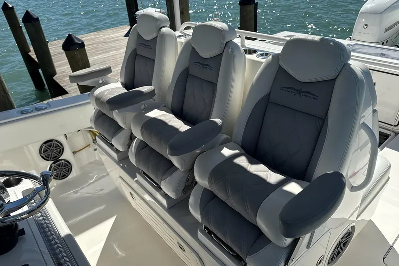Slide: The Image of 2019 Invincible 39 Open Fisherman boat with luxurious seating and ocean backdrop. - 8