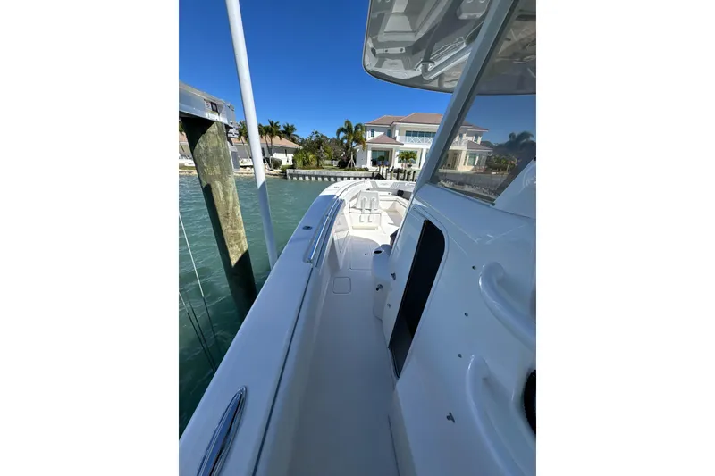 Slide: The Image of 2019 Invincible 39 Open Fisherman boat docked by waterfront homes. - 9