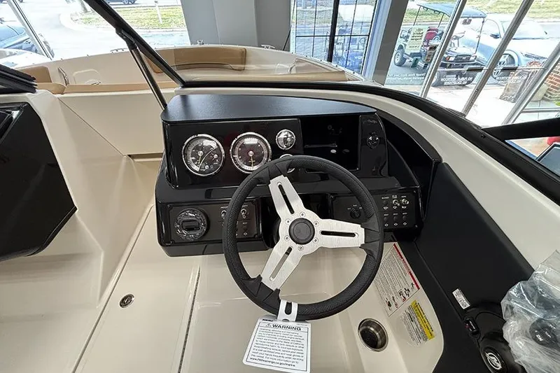Slide: The Image of 2026 Bayliner V20 boat dashboard with steering wheel and instrument panel. - 13
