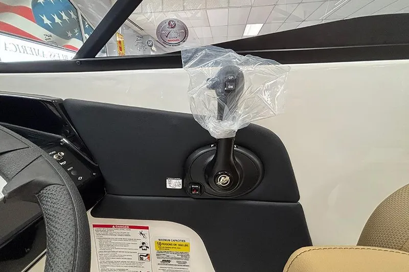 Slide: The Image of 2026 Bayliner V20 boat interior with control lever wrapped in plastic. - 14