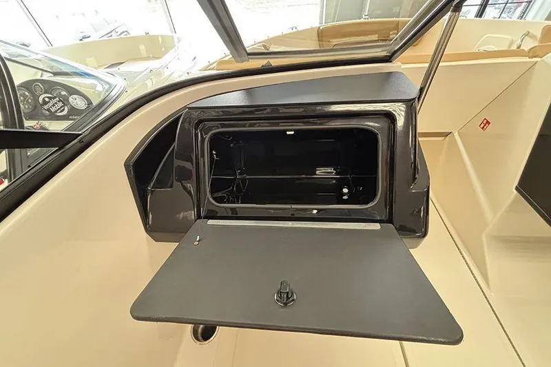 Slide: The Image of 2026 Bayliner V20 boat interior with open storage compartment. - 16
