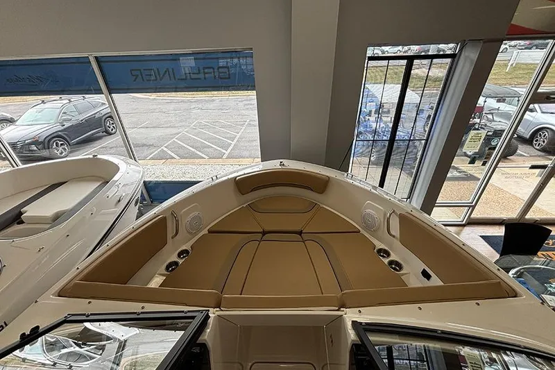 Slide: The Image of 2026 Bayliner V20 boat interior with tan seating, displayed in showroom. - 17