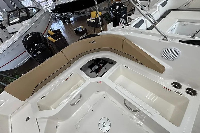 Slide: The Image of 2026 Bayliner V20 boat interior with tan seating and storage compartments. - 18