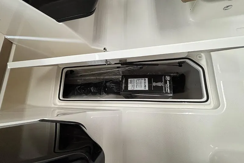 Slide: The Image of 2026 Bayliner V20 storage compartment with Mercury engine component. - 19