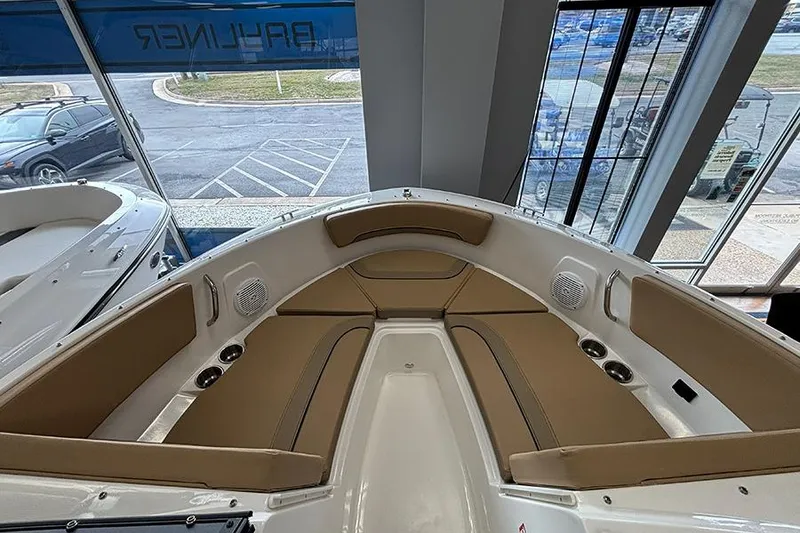 Slide: The Image of 2026 Bayliner V20 boat interior with tan seating and cup holders. - 20