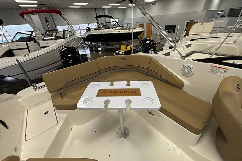 Slide: The Image of Bayliner V20 2026 boat interior with seating and table in showroom. - 23
