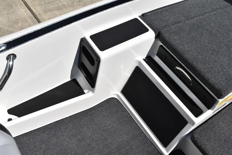 Slide: The Image of Interior view of 2026 Lowe Skorpion SS boat with gray seating and storage compartments. - 11