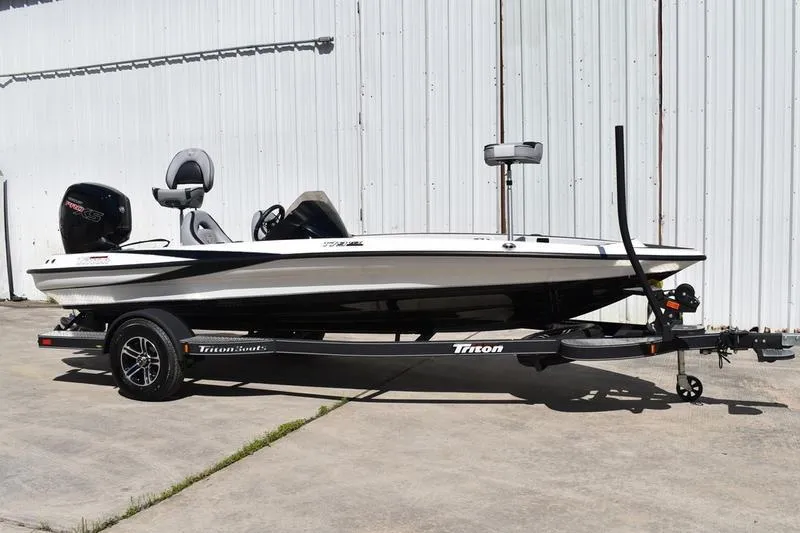 Slide: The Image of 2026 Lowe Skorpion SS fishing boat on Triton trailer, parked outdoors. - 16