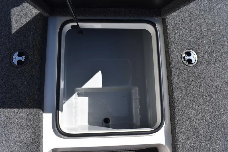 Slide: The Image of Livewell compartment in 2026 Lowe Skorpion SS boat, featuring gray carpeted interior. - 17