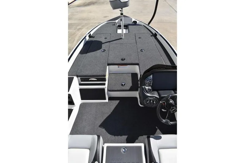 Slide: The Image of 2026 Lowe Skorpion SS boat interior with steering console and seating area. - 21