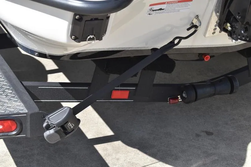 Slide: The Image of Rear view of 2026 Lowe Skorpion SS boat trailer with safety strap and hitch. - 22